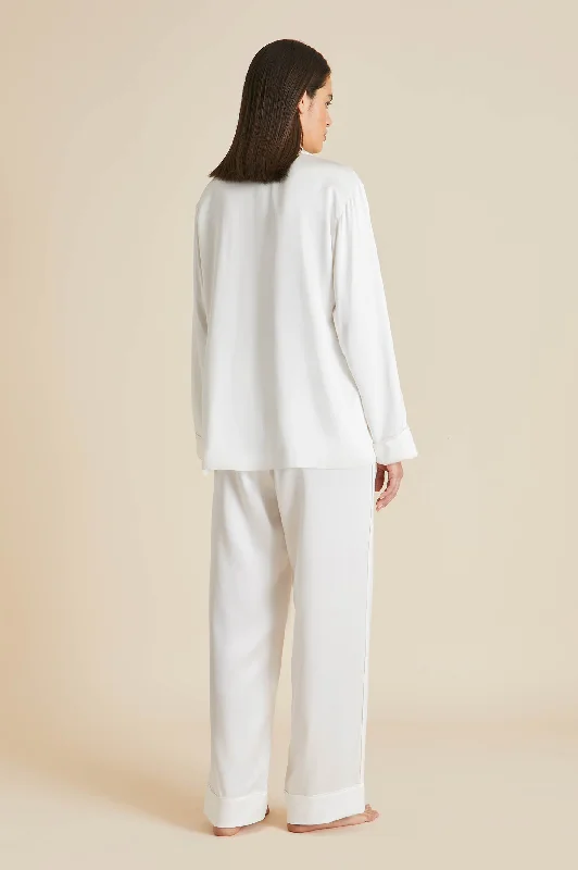 Yves Desire Ivory pajamas in Silk with Ruby and Diamond Buttons by Jessica McCormack